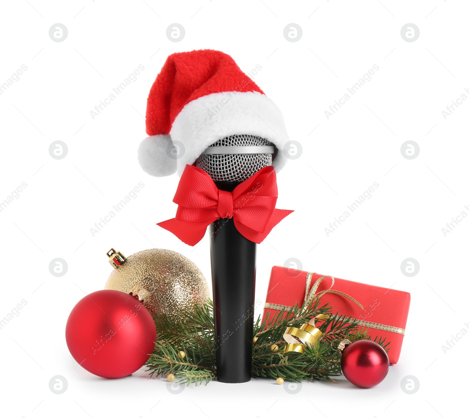 Photo of Microphone with Santa hat and decorations isolated on white. Christmas music concept