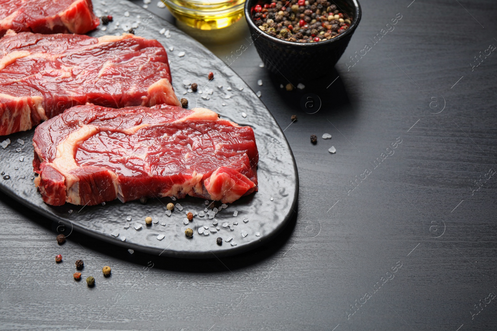 Image of Fresh marbled meat steaks on slate board