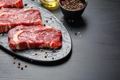 Fresh marbled meat steaks on slate board