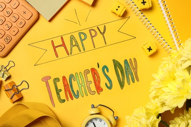 Photo of Flat lay composition with words HAPPY TEACHER'S DAY and stationery on yellow background