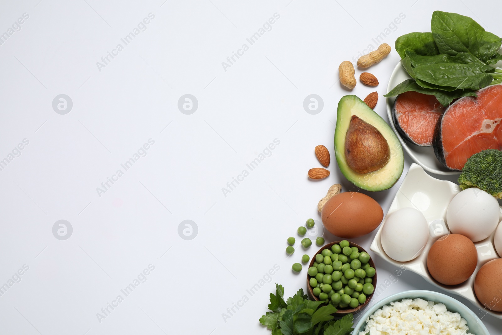 Photo of Different products rich in protein on white background, flat lay