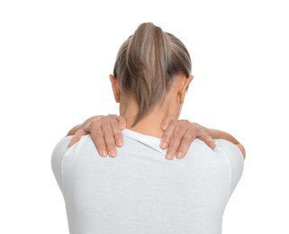 Woman suffering from pain in her neck on white background, back view