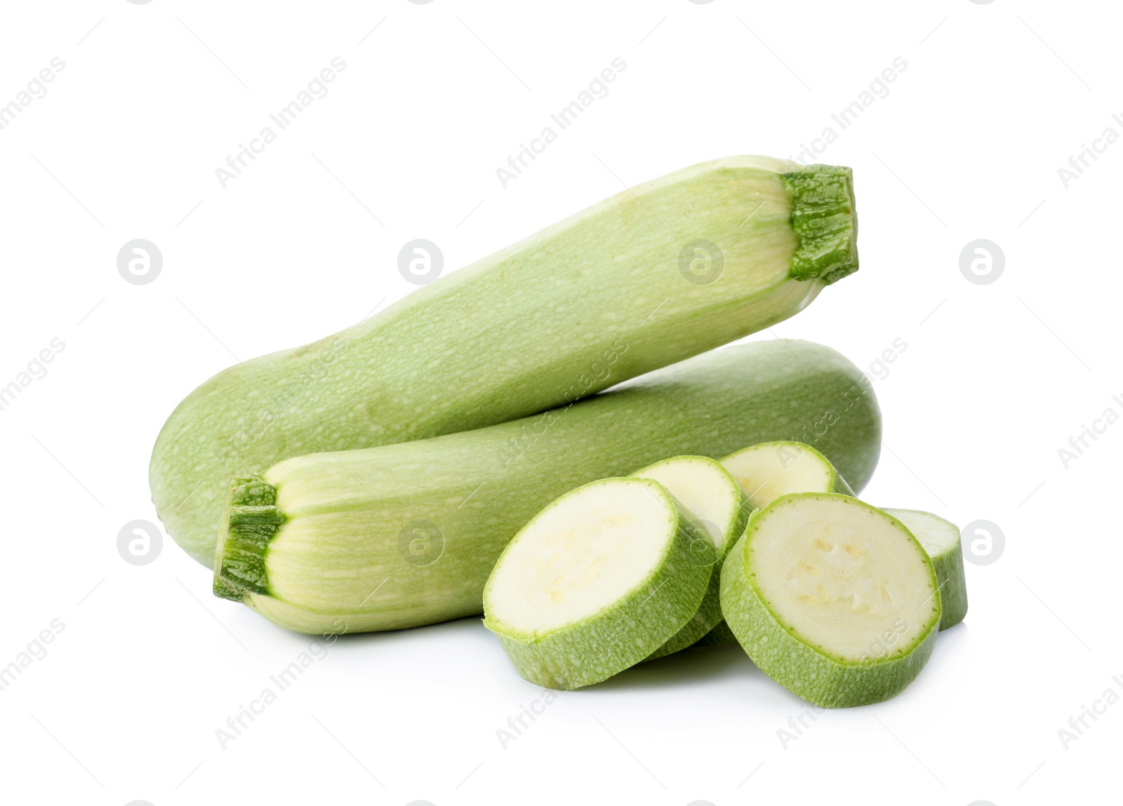 Photo of Cut and whole green ripe zucchinis on white background