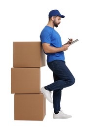 Happy young courier with stack of parcels and clipboard on white background