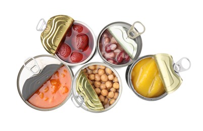 Photo of Open tin cans with different products on white background, top view