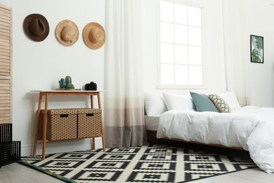 Stylish wooden table and bed in modern room interior