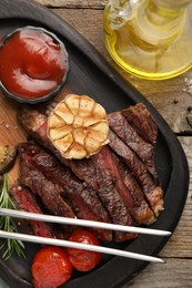 Photo of Delicious grilled beef with vegetables and tomato sauce on table, top view