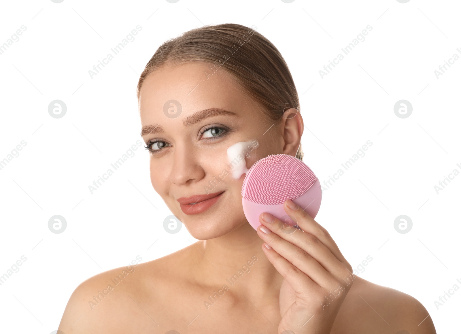 Photo of Young woman washing face with brush and cleansing foam on white background. Cosmetic products