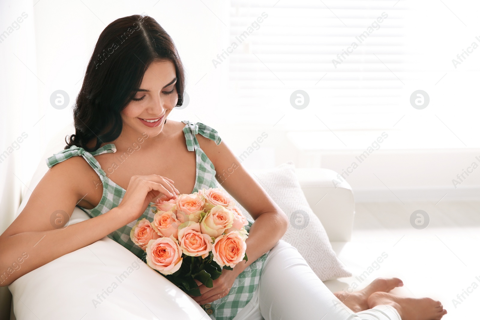 Photo of Young woman with beautiful bouquet at home. Space for text