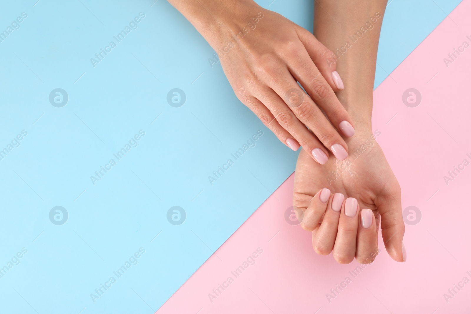 Photo of Closeup view of woman with beautiful hands on color background, space for text. Spa treatment