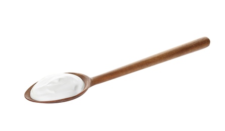 Photo of Spoon with creamy yogurt on white background