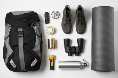 Flat lay composition with different camping equipment on white background