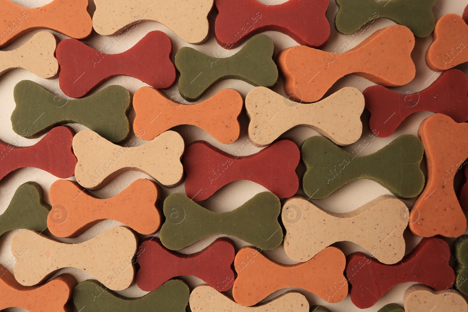 Photo of Flat lay composition with many bone shaped vitamins for pets on beige background