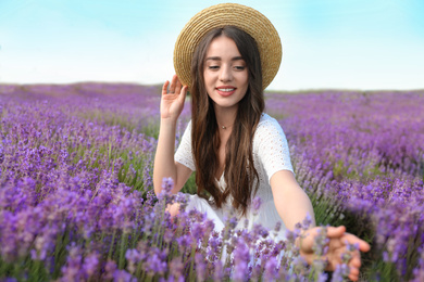 Photo of Young woman in lavender field on summer day