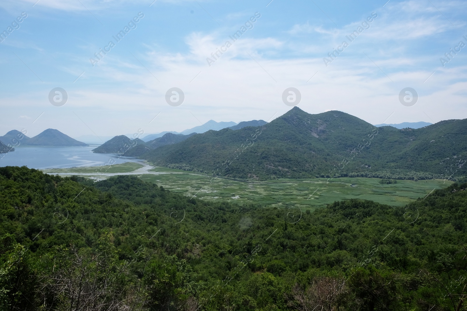 Image of Picturesque view of beautiful mountains under blue sky with clouds