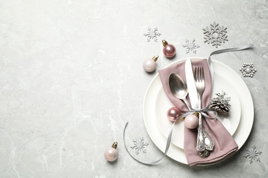 Photo of Beautiful Christmas table setting and festive decor on light grey marble background, flat lay. Space for text