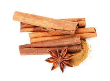 Photo of Dry aromatic cinnamon sticks, powder and anise star isolated on white, top view