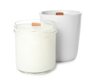 Photo of Beautiful candles with wooden wicks on white background