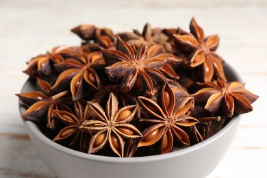 Photo of Many aromatic anise stars in bowl, closeup