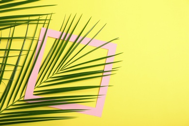 Photo of Flat lay composition with tropical leaves on color background