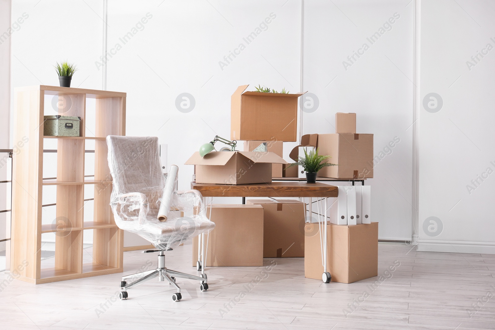 Photo of Carton boxes with stuff in room. Office move concept