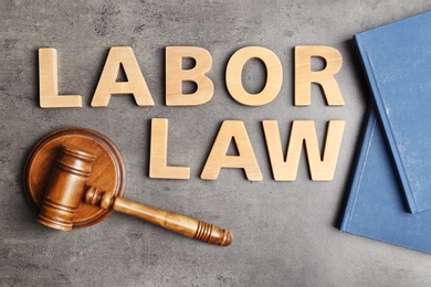 Flat lay composition with words LABOR LAW on grey background