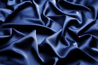 Delicate dark blue silk fabric as background, closeup view