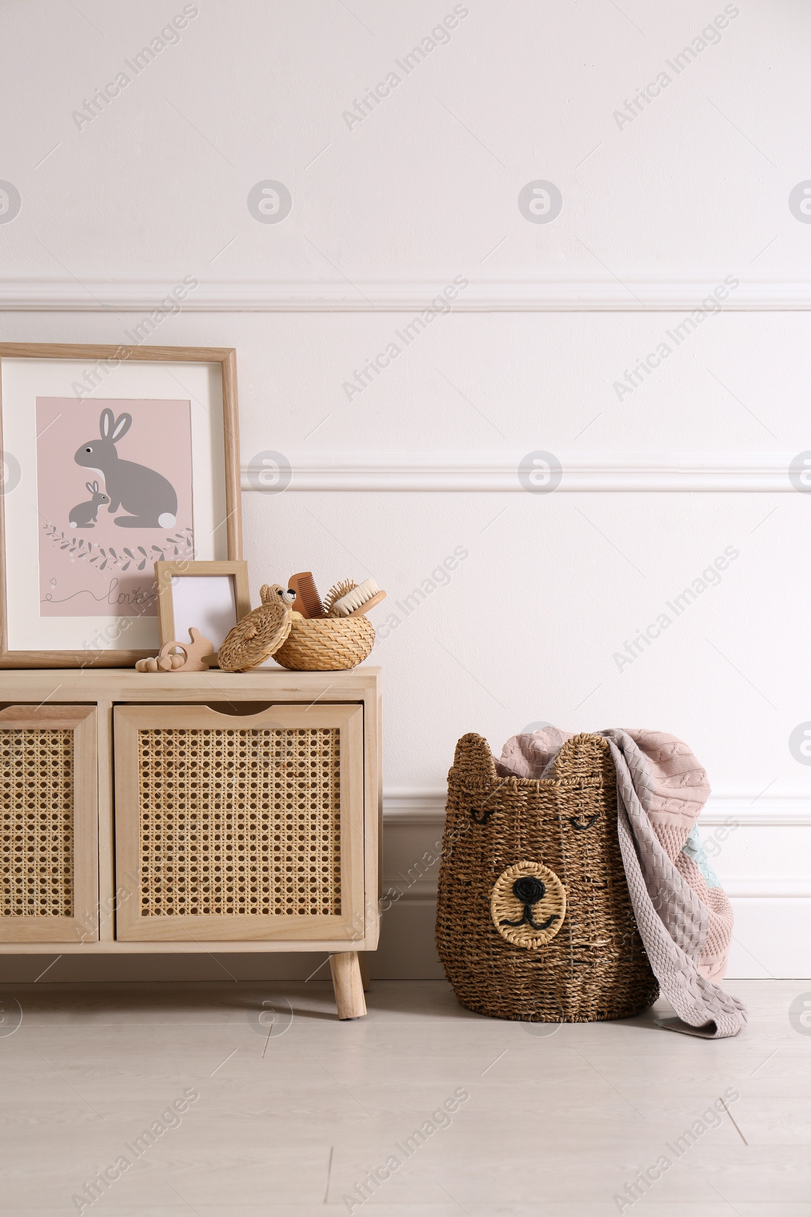 Photo of Modern child room interior with wooden cabinet and different accessories. Space for text