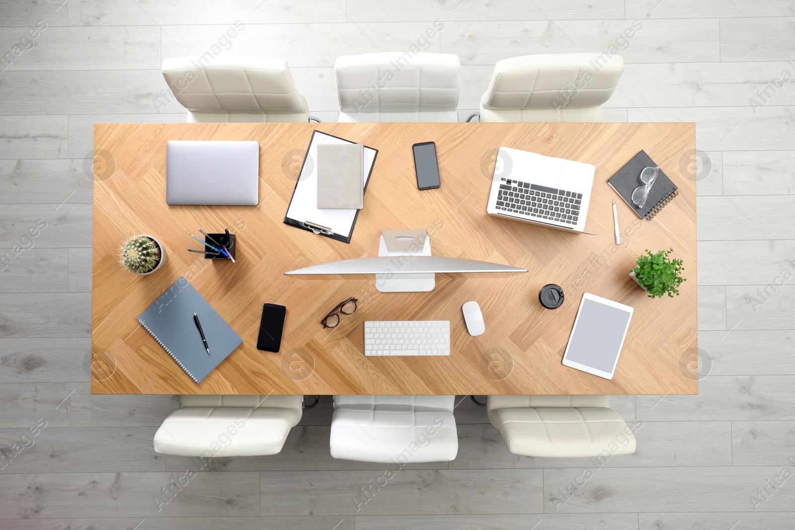 Photo of Modern office table with devices and chairs, top view