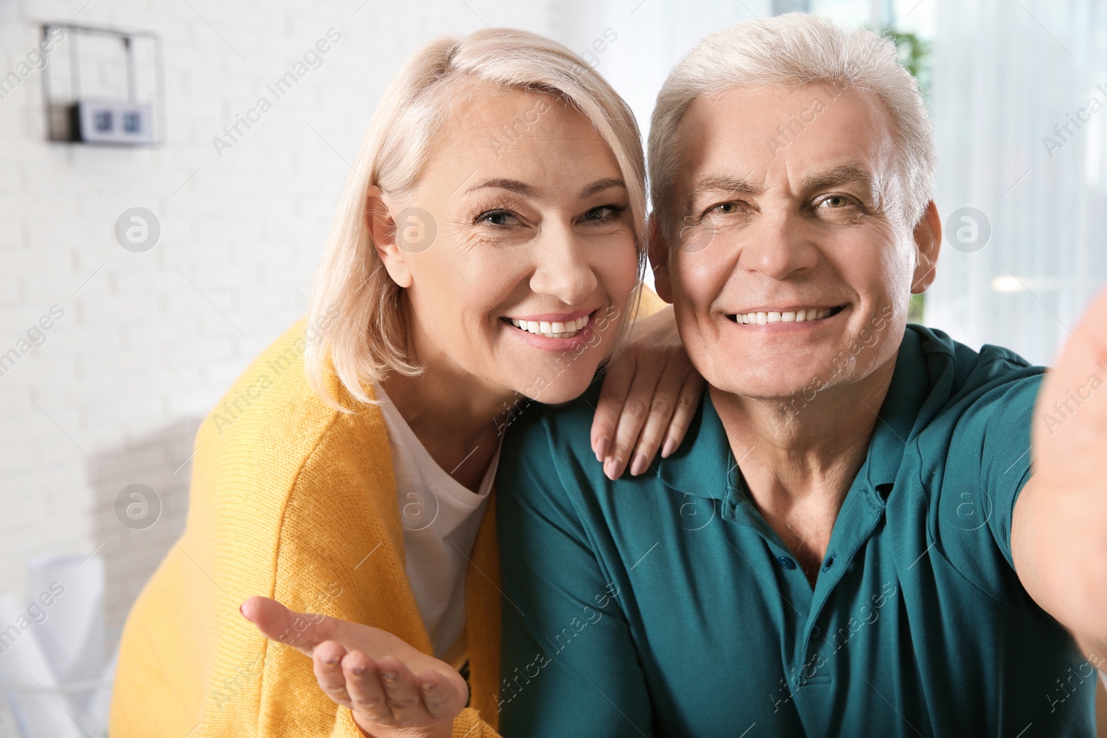 Photo of Mature couple using video chat at home, view from web camera