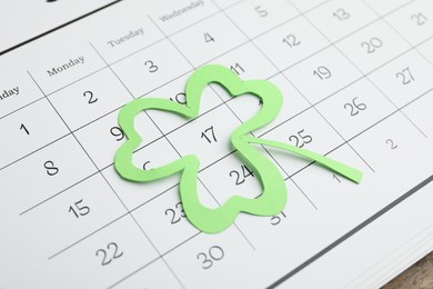 Photo of 17th March marked with paper clover leaf on calendar. St. Patrick's Day celebration