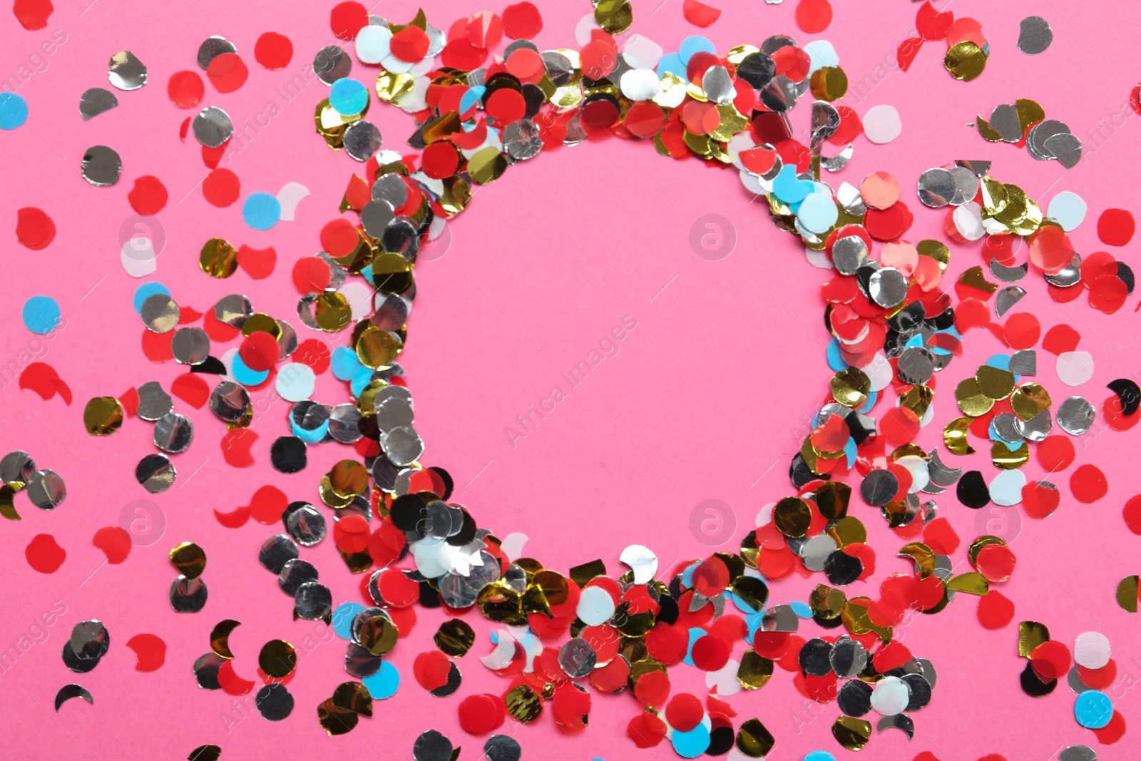 Photo of Frame of shiny colorful confetti on pink background, flat lay. Space for text