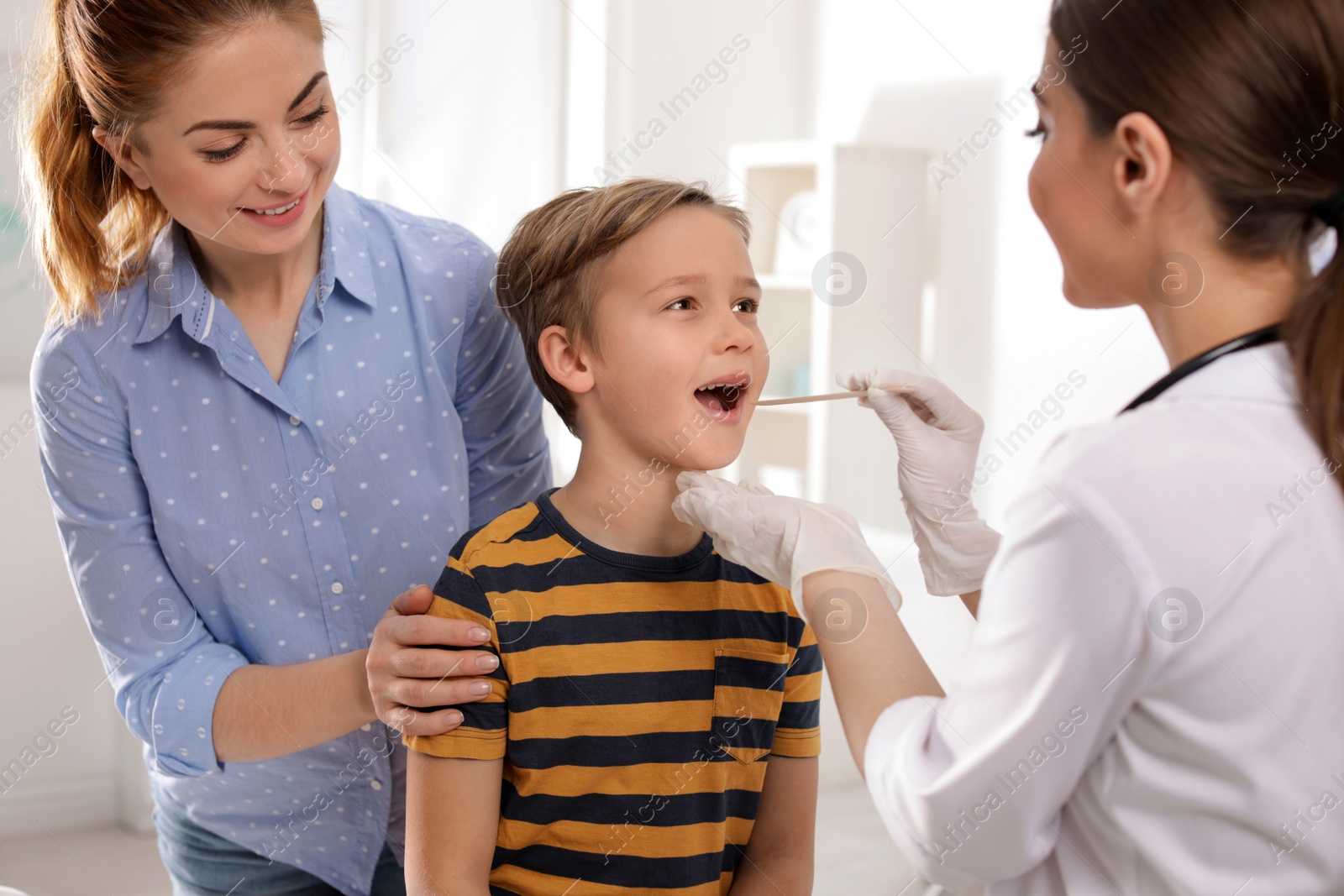 Photo of Mother with child visiting doctor in hospital