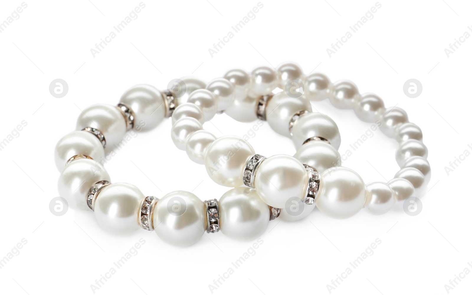 Photo of Elegant pearl bracelets on white background. Luxury jewelry