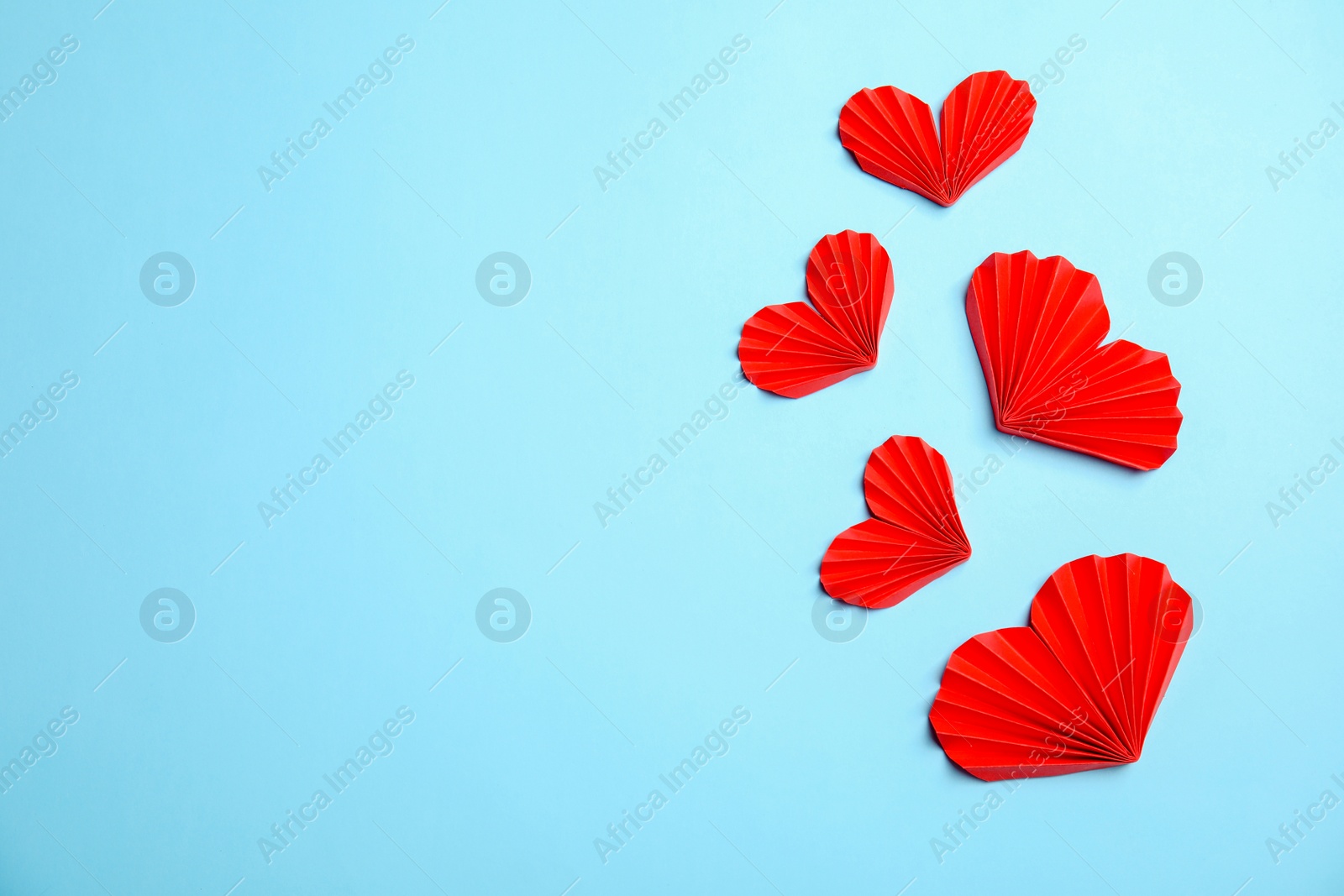 Photo of Small paper hearts on color background, top view