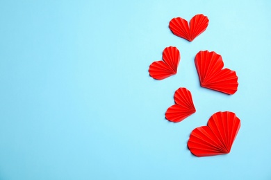 Photo of Small paper hearts on color background, top view