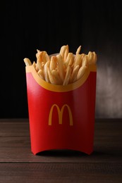 Photo of MYKOLAIV, UKRAINE - AUGUST 12, 2021: Big portion of McDonald's French fries on wooden table