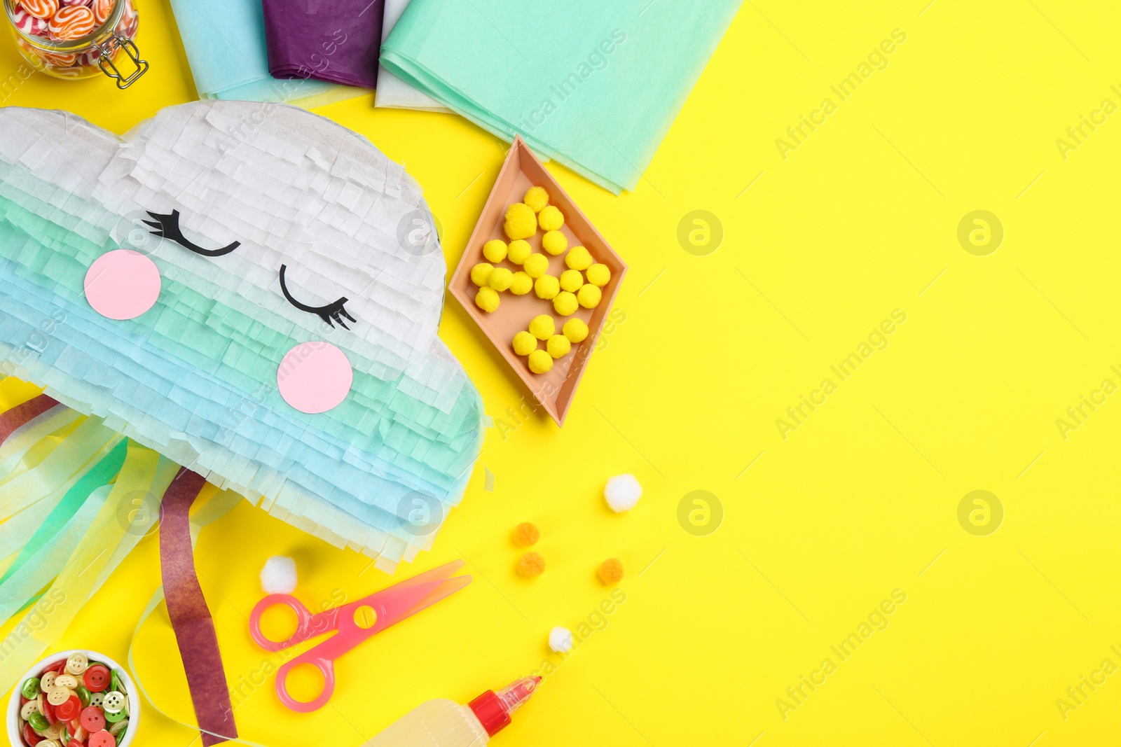 Photo of Flat lay composition with cardboard cloud on yellow background, space for text. Pinata diy