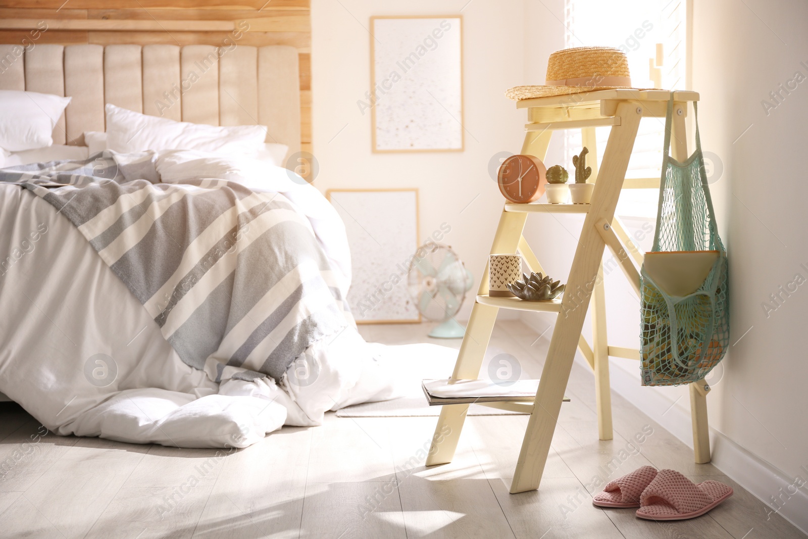 Photo of Decorative ladder with different stuff in stylish bedroom. Idea for interior design