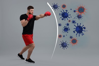 Image of Sporty man with boxing gloves exercising on grey background. Strong immunity helping fight with viruses