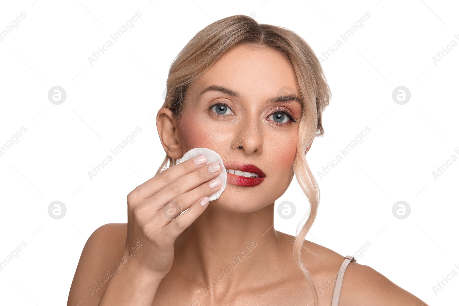 Photo of Beautiful woman removing makeup with cotton pad on white background