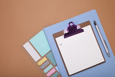 Photo of To do notes, stationery and planner on brown background, flat lay. Space for text
