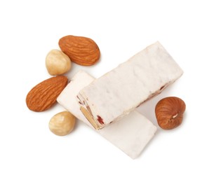 Photo of Pieces of delicious nougat and nuts on white background, top view