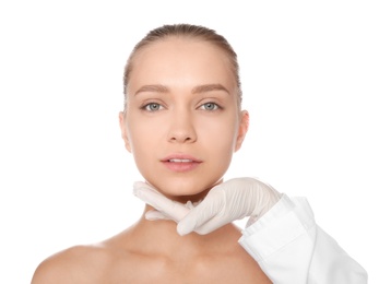 Photo of Doctor examining young woman face before cosmetic surgery on white background