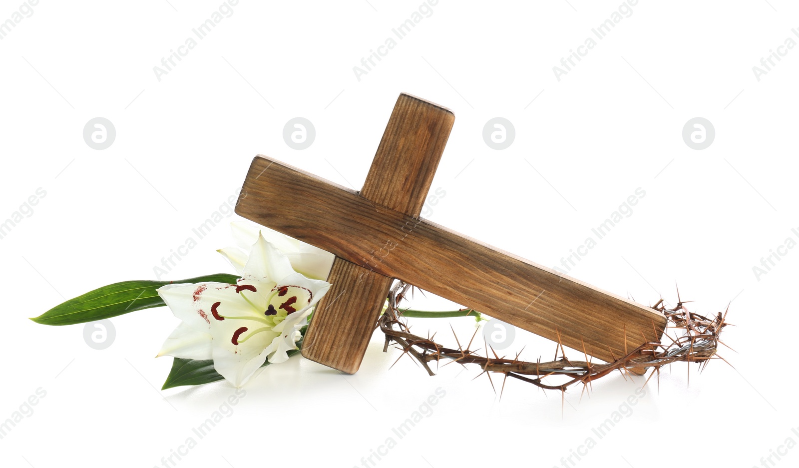 Photo of Wooden cross, crown of thorns and blossom lilies on white background