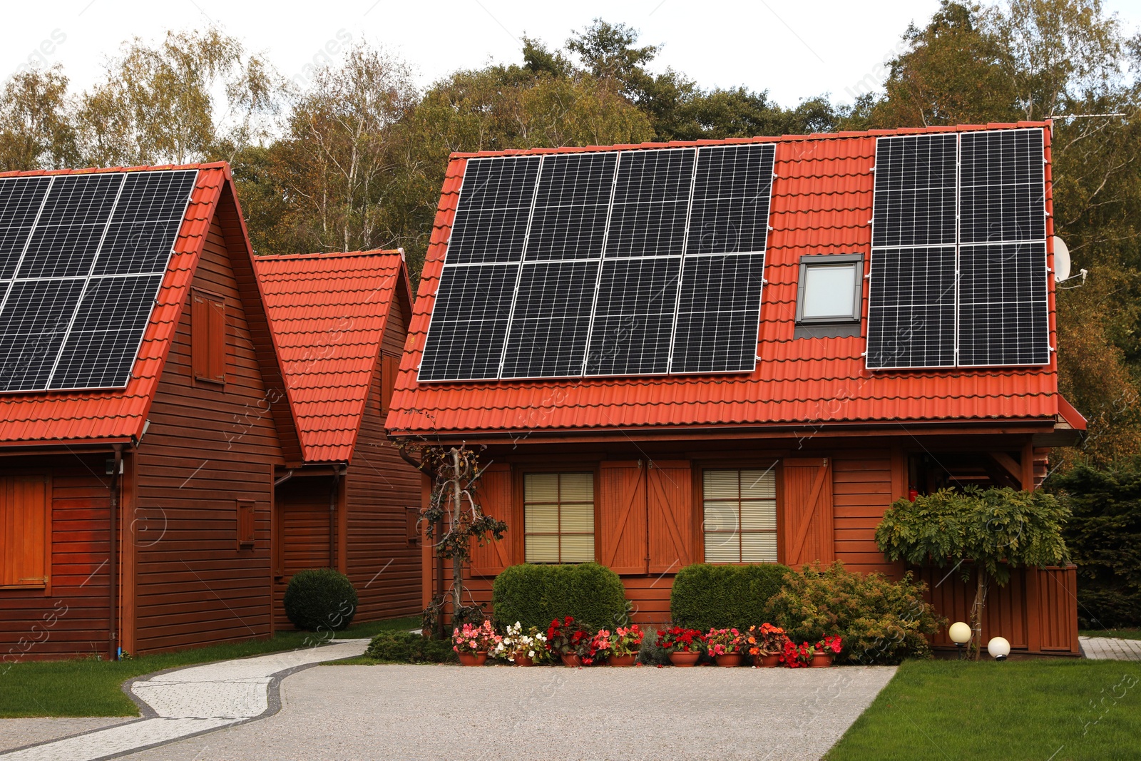 Photo of Beautiful houses with solar panels outdoors. Real estate for rent