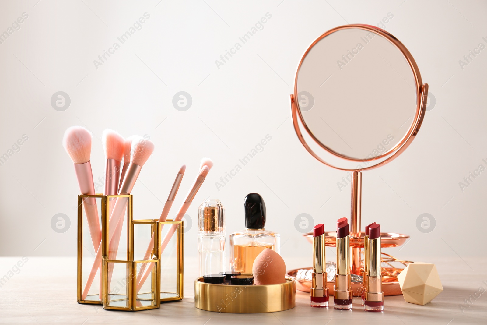Photo of Set of makeup products and brushes on table
