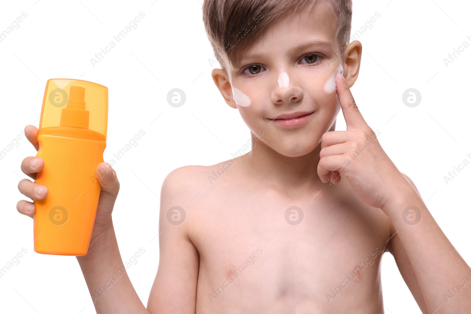 Photo of Smiling boy applying sun protection cream on white background