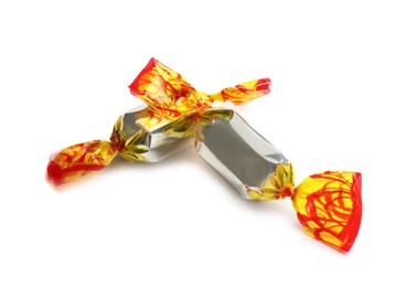 Delicious candies wrapped in foil on white background