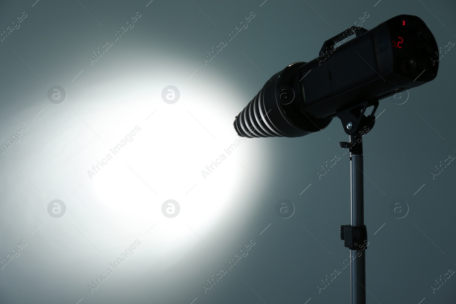 Photo of Studio lighting against gray background. Professional photo equipment